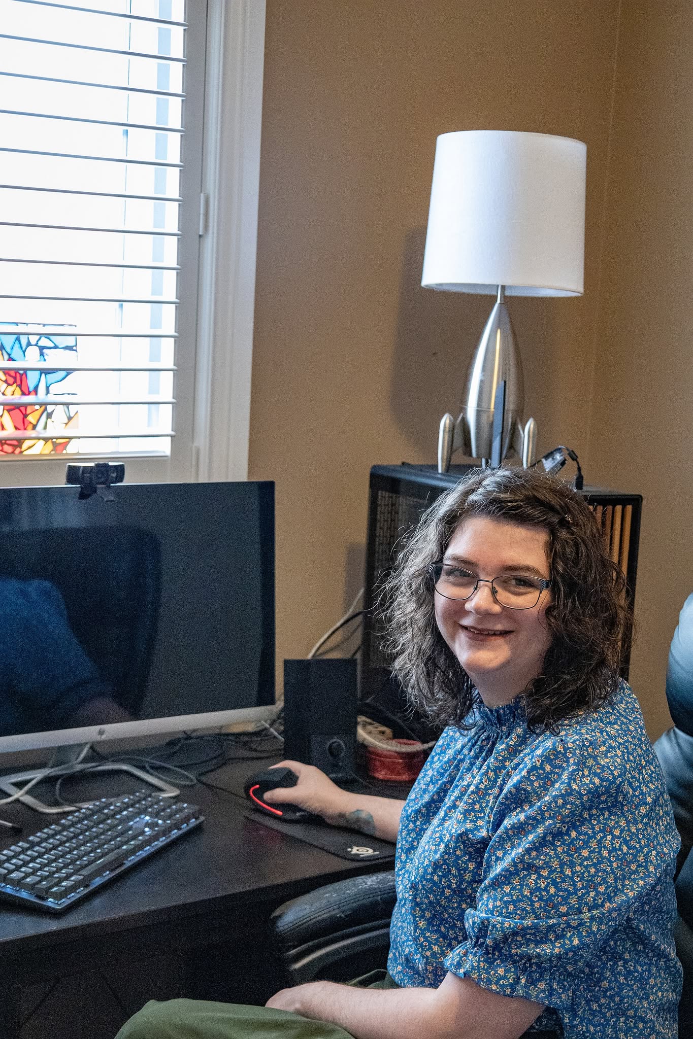 Annie - Registered Psychotherapist (Qualifying) sitting at her desk where she conducts online counselling sessions.